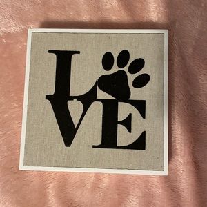 Wall decor that says “love” with a paw print